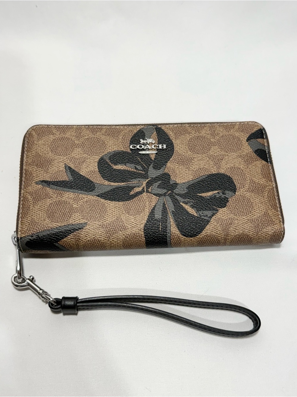 Coach Brown Signature Canvas Zip Wristlet with Black Bow Print